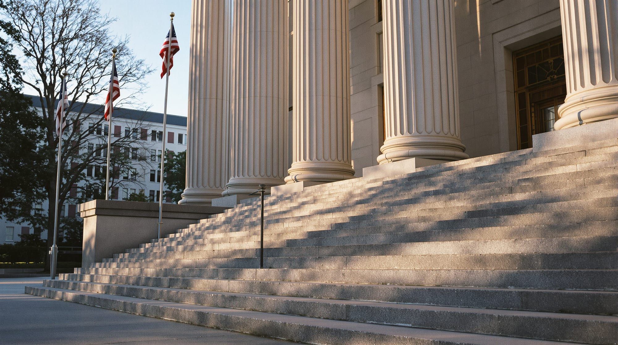 Empty stone courthouse steps and columns in early morning light